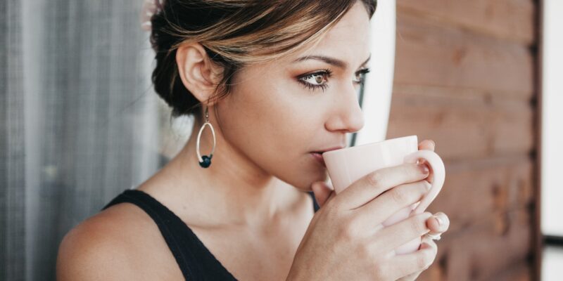 Woman sipping herbal tea as a calming exercise for anxiety